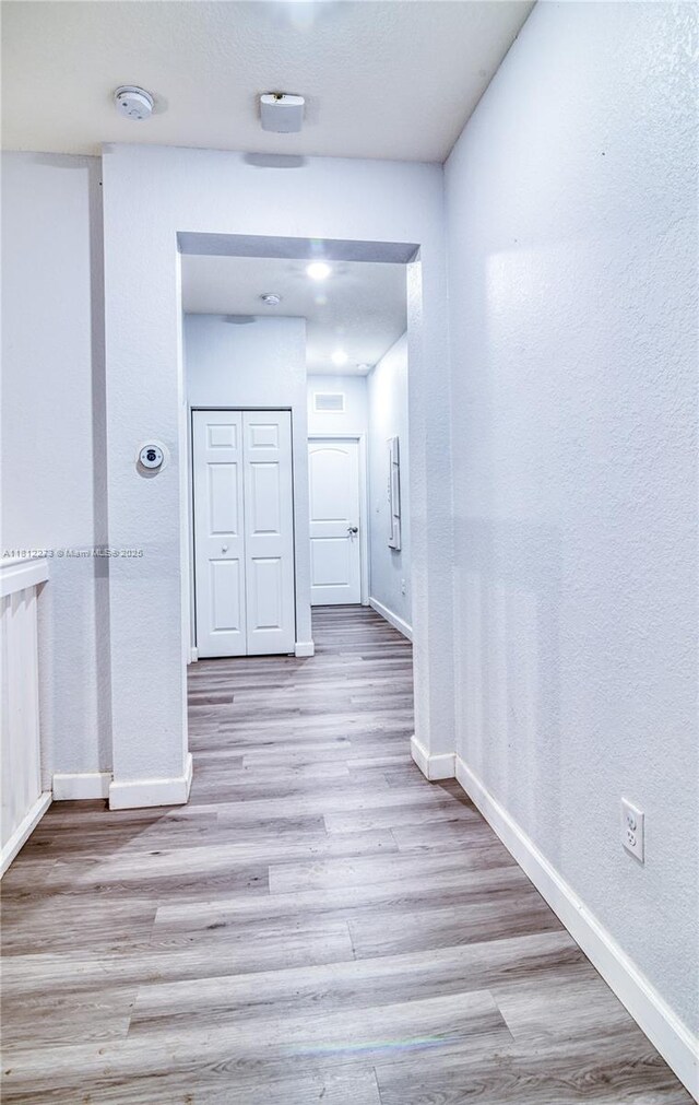 6489 N Anise Ct, Davie, FL 33314 - hall with wood finished floors and a textured wall