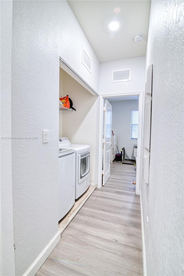6489 N Anise Ct, Davie, FL 33314 - laundry room with washer and dryer, a textured wall, wood finished floors, and baseboards