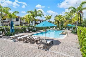 6489 N Anise Ct, Davie, FL 33314 - community pool featuring a patio