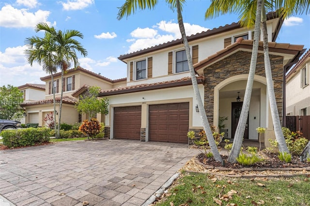 3401 SE 5th St, Homestead, FL 33033 - view of front of property with stone siding, stucco siding, a garage, and decorative driveway
