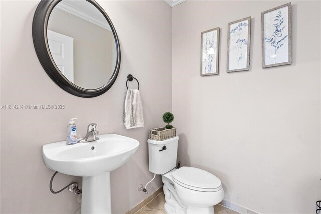 3401 SE 5th St, Homestead, FL 33033 - half bath featuring baseboards, toilet, tile patterned flooring, and a sink