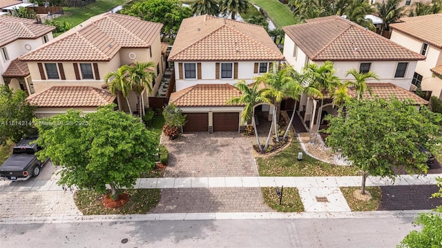 3401 SE 5th St, Homestead, FL 33033 - view of front of house with a tile roof, decorative driveway, stucco siding, and a residential view