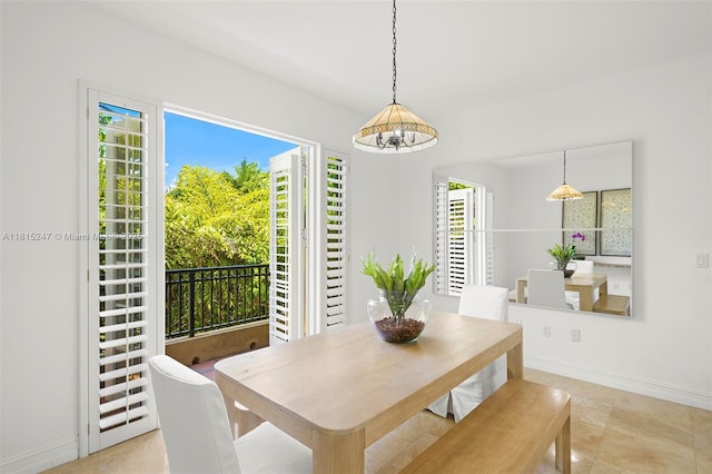 615 Santander Ave Unit C, Coral Gables, FL 33134 - dining space featuring a chandelier and baseboards