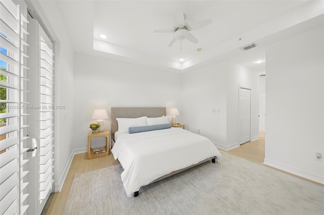 615 Santander Ave Unit C, Coral Gables, FL 33134 - bedroom featuring light wood-type flooring, recessed lighting, baseboards, a tray ceiling, and ceiling fan