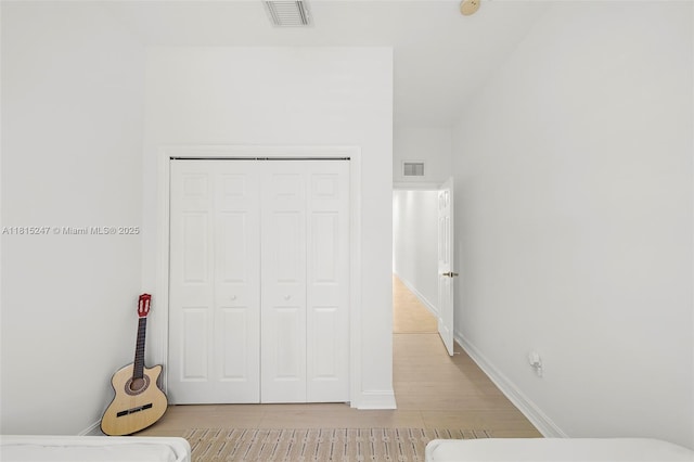 615 Santander Ave Unit C, Coral Gables, FL 33134 - unfurnished bedroom featuring light wood finished floors, a closet, and baseboards
