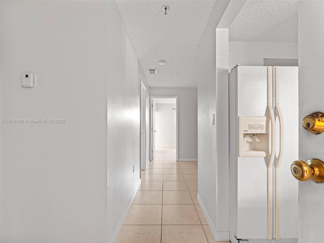7905 W 30th Ct Unit 204, Hialeah, FL 33018 - corridor with a textured ceiling, baseboards, and light tile patterned floors