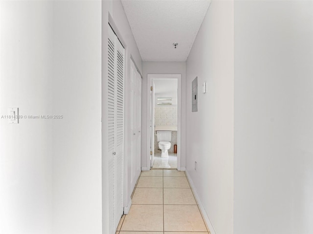 7905 W 30th Ct Unit 204, Hialeah, FL 33018 - hallway featuring electric panel, light tile patterned flooring, and baseboards