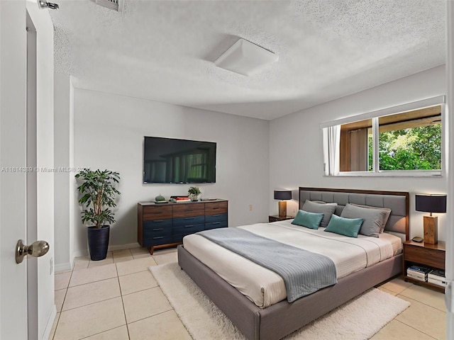 7905 W 30th Ct Unit 204, Hialeah, FL 33018 - bedroom featuring a textured ceiling and tile patterned flooring