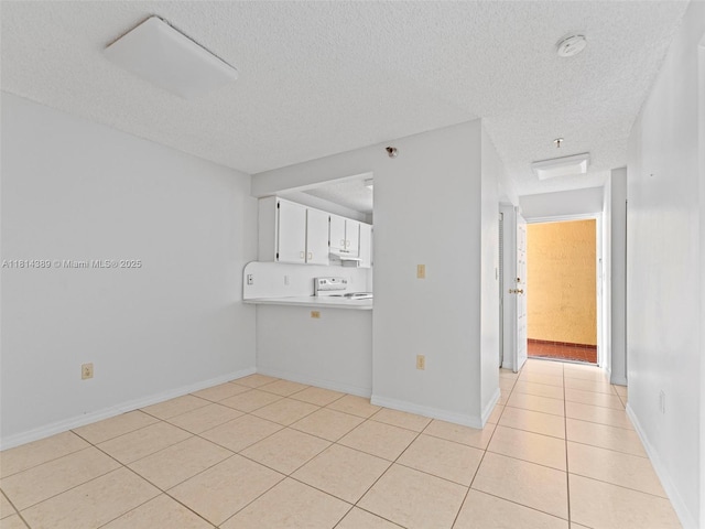 7905 W 30th Ct Unit 204, Hialeah, FL 33018 - unfurnished room featuring light tile patterned floors, a textured ceiling, baseboards, and a smoke detector