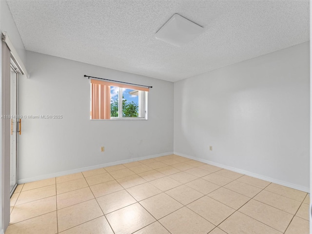 7905 W 30th Ct Unit 204, Hialeah, FL 33018 - unfurnished room featuring a textured ceiling, baseboards, and light tile patterned floors