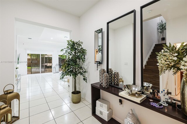 15104 SW 176th St, Miami, FL 33187 - hall featuring light tile patterned floors, stairway, and baseboards
