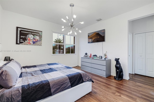 15104 SW 176th St, Miami, FL 33187 - bedroom featuring a chandelier, wood finished floors, and baseboards