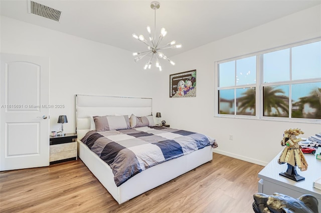 15104 SW 176th St, Miami, FL 33187 - bedroom with a chandelier, light wood-style flooring, and baseboards