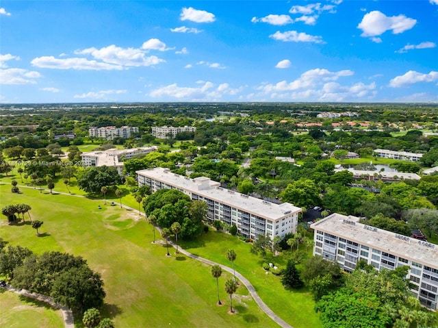 3850 E Oaks Clubhouse Dr Unit 504, Pompano Beach, FL 33069 - bird's eye view of apartment complex / building, a local golf course, and a tree filled landscape
