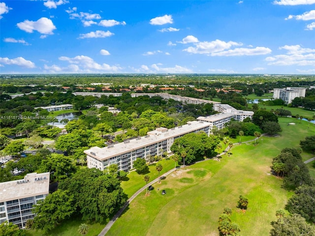 3850 E Oaks Clubhouse Dr Unit 504, Pompano Beach, FL 33069 - aerial view of apartment complex / building, a golf club, a nearby body of water, and a tree filled landscape