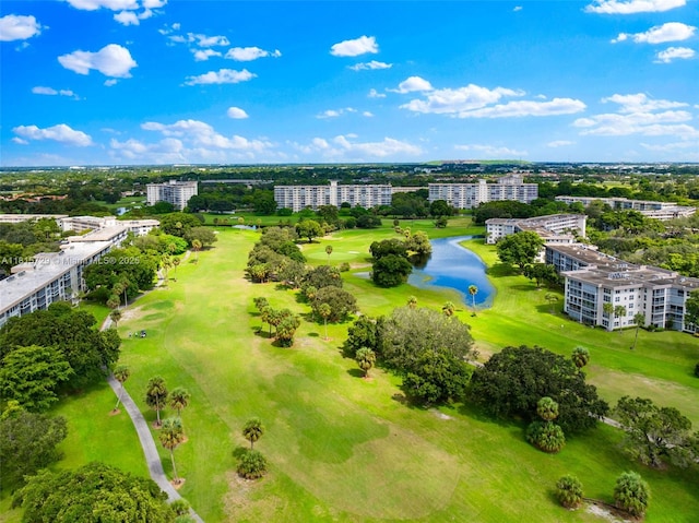 3850 E Oaks Clubhouse Dr Unit 504, Pompano Beach, FL 33069 - bird's eye view of apartment complex, a local golf course, a large body of water, and a tree filled landscape