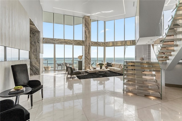 1300 Brickell Bay Dr Unit 4400, Miami, FL 33131 - living room with a high ceiling, marble tiled floors, a water view, healthy amount of natural light, and stairs