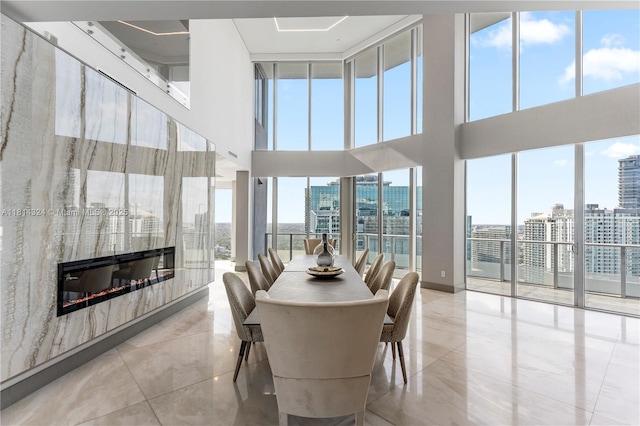 1300 Brickell Bay Dr Unit 4400, Miami, FL 33131 - dining space with a fireplace, a high ceiling, and a city view