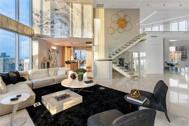 1300 Brickell Bay Dr Unit 4400, Miami, FL 33131 - living room with a towering ceiling, stairs, and a city view
