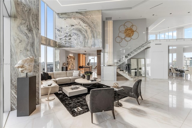1300 Brickell Bay Dr Unit 4400, Miami, FL 33131 - living room featuring a towering ceiling, stairway, plenty of natural light, and marble tiled floors