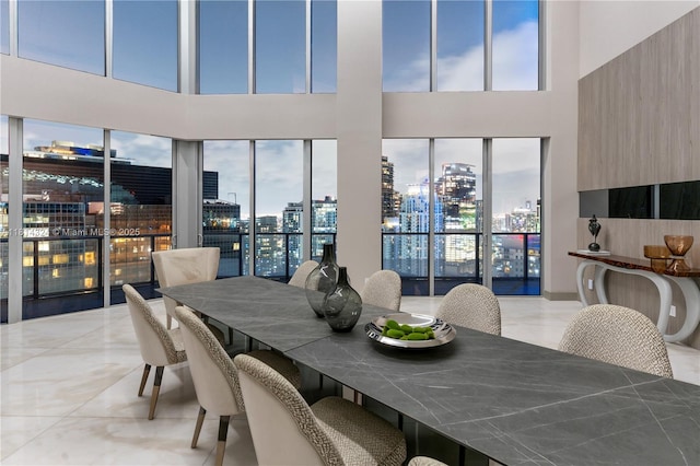 1300 Brickell Bay Dr Unit 4400, Miami, FL 33131 - dining space featuring a city view, a towering ceiling, and light marble finish flooring