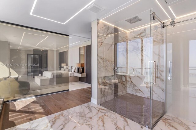 1300 Brickell Bay Dr Unit 4400, Miami, FL 33131 - bathroom with marble tiled floors and a marble finish shower