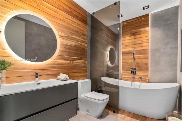 1300 Brickell Bay Dr Unit 4400, Miami, FL 33131 - bathroom featuring a soaking tub, vanity, wood walls, toilet, and wood finished floors