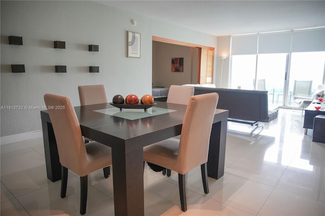4001 S Ocean Dr Unit 11A, Hollywood, FL 33019 - dining room featuring expansive windows and baseboards