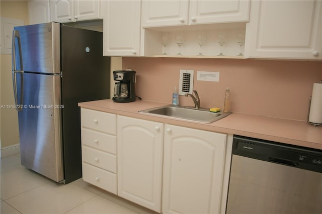 4001 S Ocean Dr Unit 11A, Hollywood, FL 33019 - kitchen featuring appliances with stainless steel finishes, a sink, light tile patterned floors, and light countertops