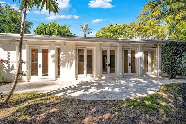345 Harbor Ln, Key Biscayne, FL 33149 - back of property featuring french doors, a patio area, and stucco siding