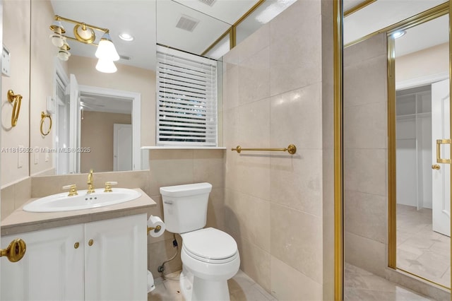 345 Harbor Ln, Key Biscayne, FL 33149 - full bathroom with toilet, tile walls, vanity, a tile shower, and tile patterned flooring