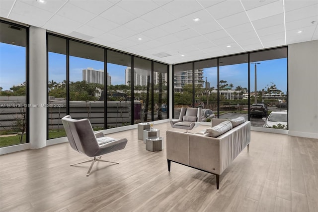 20505 E Country Club Dr Unit 138, Aventura, FL 33180 - living room with floor to ceiling windows, wood finished floors, plenty of natural light, and a drop ceiling