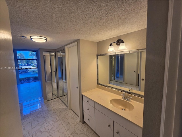 20505 E Country Club Dr Unit 138, Aventura, FL 33180 - bathroom with vanity, marble finish flooring, a textured ceiling, and a textured wall