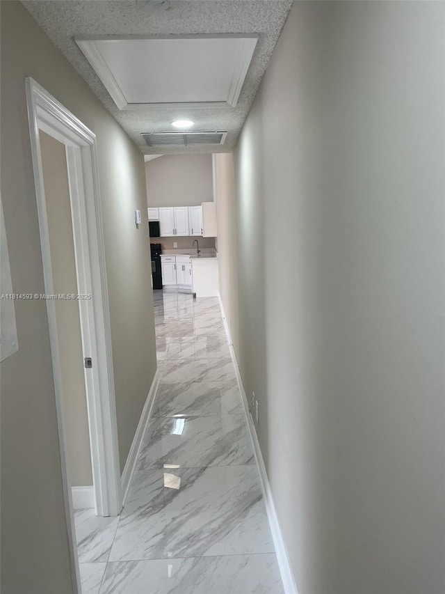 5416 Eagle Lake Dr Unit 4, Palm Beach Gardens, FL 33418 - hallway with light marble finish flooring and a textured ceiling