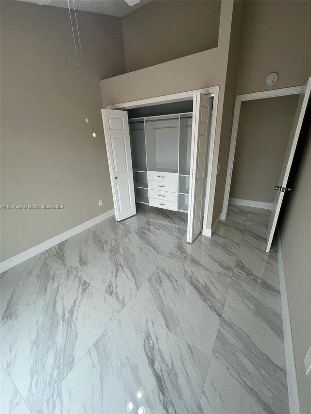5416 Eagle Lake Dr Unit 4, Palm Beach Gardens, FL 33418 - unfurnished room with a ceiling fan, marble finish flooring, vaulted ceiling, and a textured ceiling