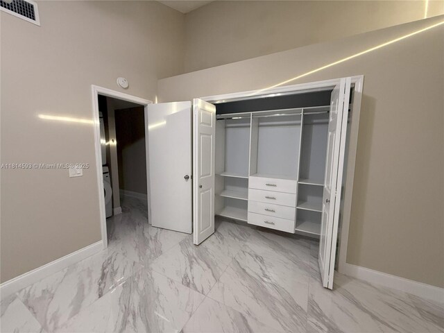 5416 Eagle Lake Dr Unit 4, Palm Beach Gardens, FL 33418 - corridor with light marble finish flooring and a textured ceiling