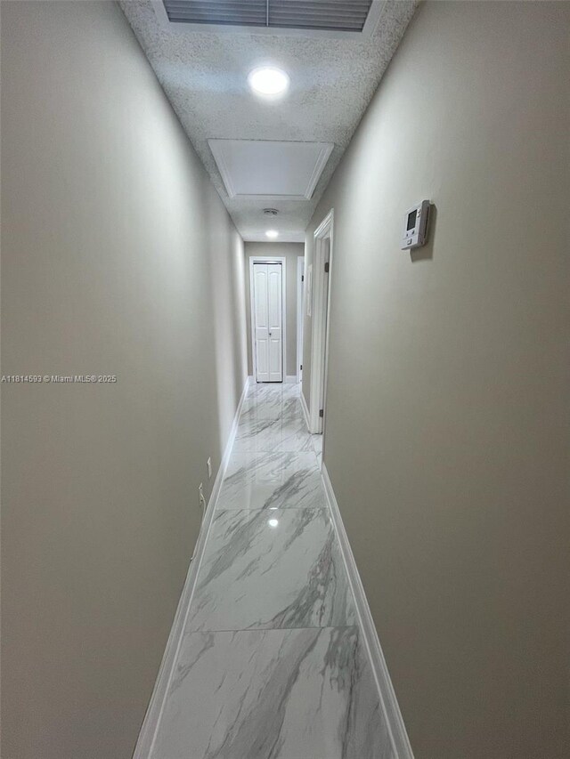 5416 Eagle Lake Dr Unit 4, Palm Beach Gardens, FL 33418 - laundry area featuring stacked washing machine and dryer, marble finish floors, and a textured ceiling