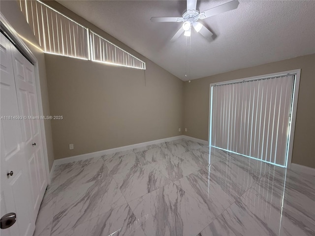 5416 Eagle Lake Dr Unit 4, Palm Beach Gardens, FL 33418 - spare room featuring marble finish floors, a ceiling fan, vaulted ceiling, and a textured ceiling