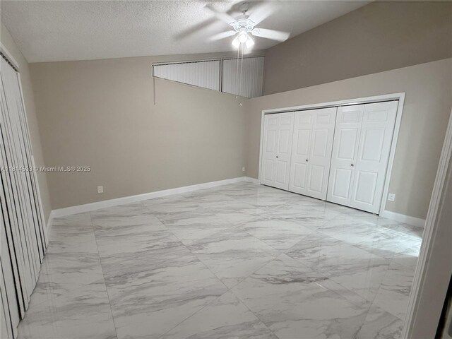 5416 Eagle Lake Dr Unit 4, Palm Beach Gardens, FL 33418 - unfurnished bedroom with marble look tiles, a ceiling fan, a closet, and a textured ceiling
