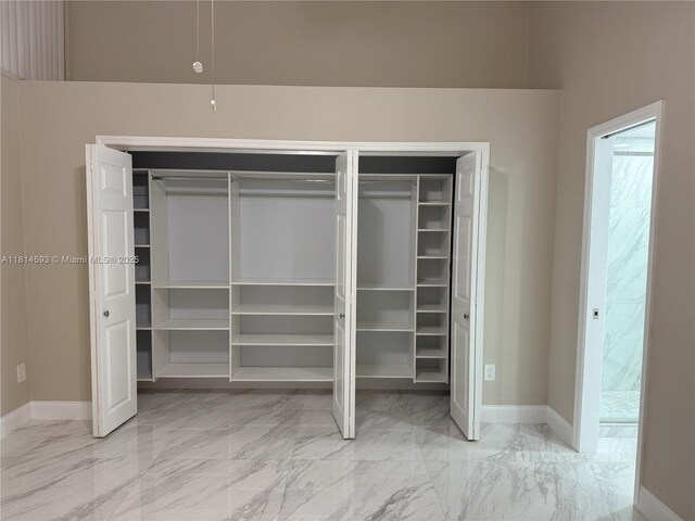 5416 Eagle Lake Dr Unit 4, Palm Beach Gardens, FL 33418 - spare room featuring marble look tiles, ceiling fan, lofted ceiling, and a textured ceiling