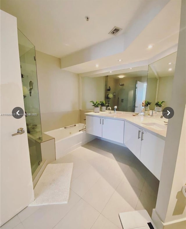 888 Brickell Key Dr Unit 2209, Miami, FL 33131 - bathroom featuring a stall shower, double vanity, a garden tub, tile patterned floors, and recessed lighting