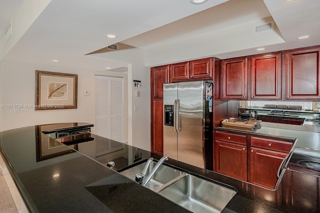 5600 Collins Ave Unit 10E, Miami Beach, FL 33140 - kitchen featuring dark brown cabinets, stainless steel fridge, recessed lighting, a sink, and dark countertops