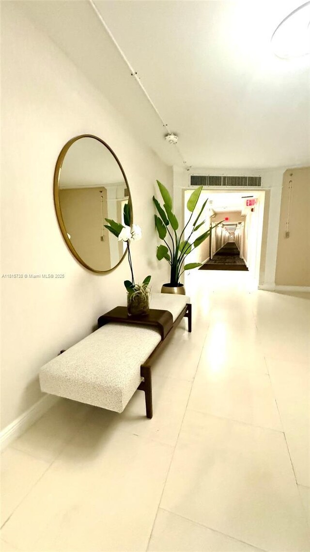 5600 Collins Ave Unit 10E, Miami Beach, FL 33140 - hallway featuring tile patterned floors and baseboards