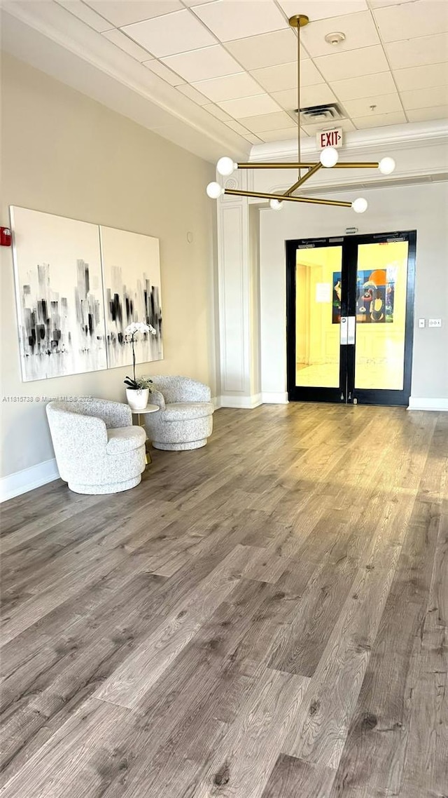 5600 Collins Ave Unit 10E, Miami Beach, FL 33140 - living area with wood finished floors, baseboards, and a drop ceiling