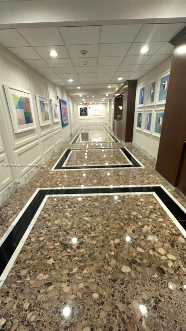 5600 Collins Ave Unit 10E, Miami Beach, FL 33140 - playroom featuring inlaid floor details, baseboards, recessed lighting, a drop ceiling, and a decorative wall