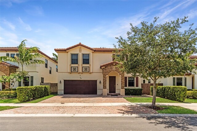 724 SE 37th Ave, Homestead, FL 33033 - mediterranean / spanish-style home featuring stucco siding, an attached garage, decorative driveway, a tile roof, and stone siding