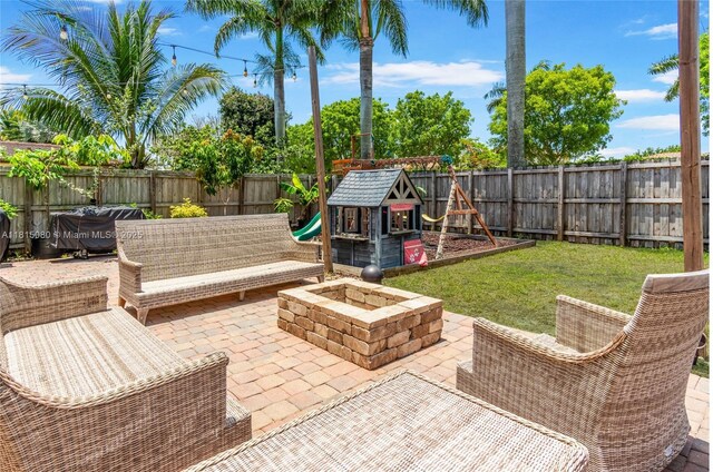 724 SE 37th Ave, Homestead, FL 33033 - view of patio / terrace with a playground and an outdoor fire pit