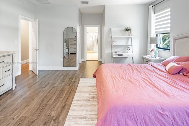724 SE 37th Ave, Homestead, FL 33033 - bedroom with wood finished floors, ensuite bathroom, and baseboards