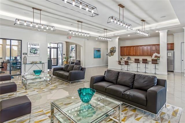 724 SE 37th Ave, Homestead, FL 33033 - living room with arched walkways, light tile patterned flooring, baseboards, ornamental molding, and a tray ceiling