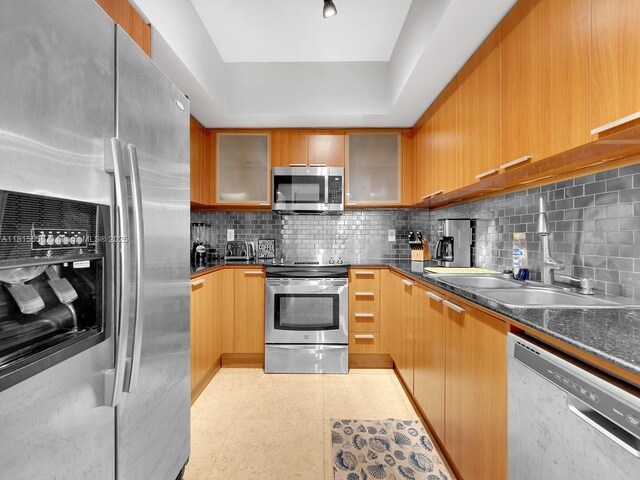 16699 Collins Ave Unit 2906, Sunny Isles Beach, FL 33160 - kitchen with appliances with stainless steel finishes, decorative backsplash, glass insert cabinets, and a sink